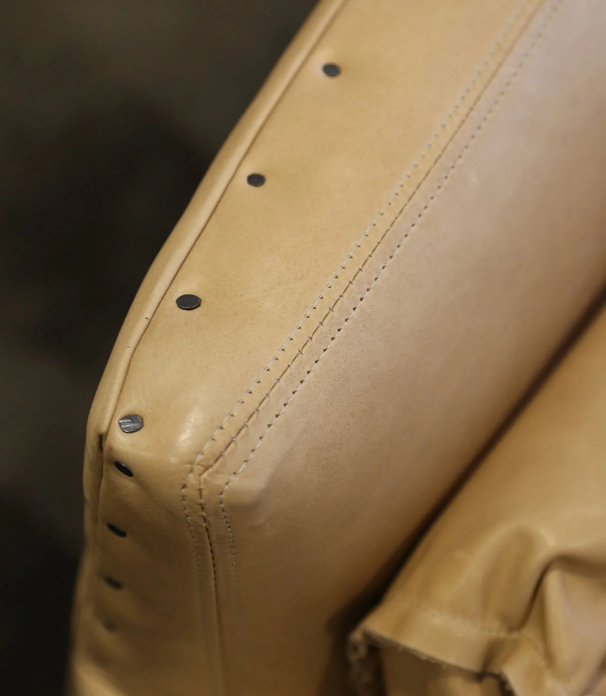 Rustic nail head detail at leather seating