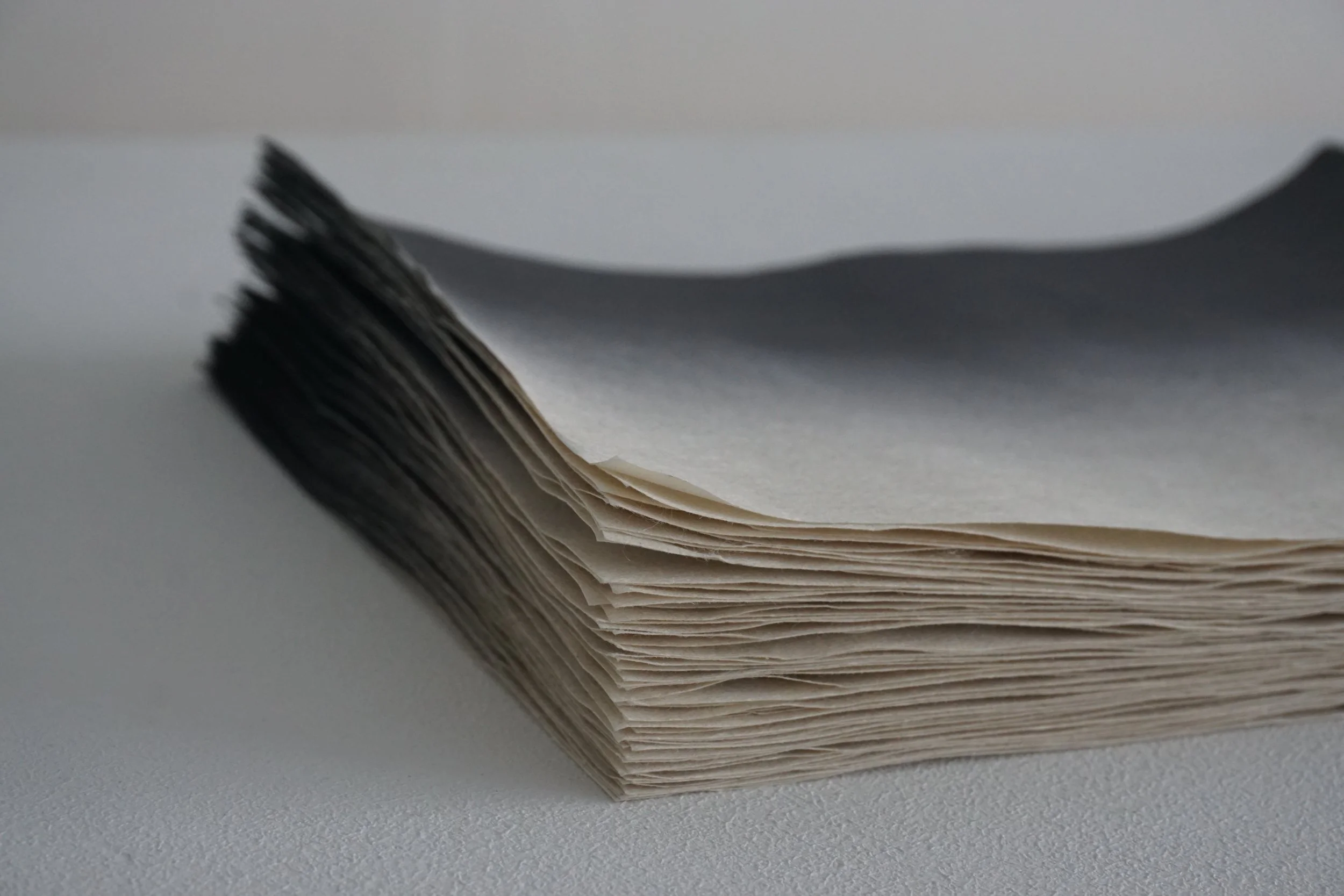 black hand dyed stacks of paper