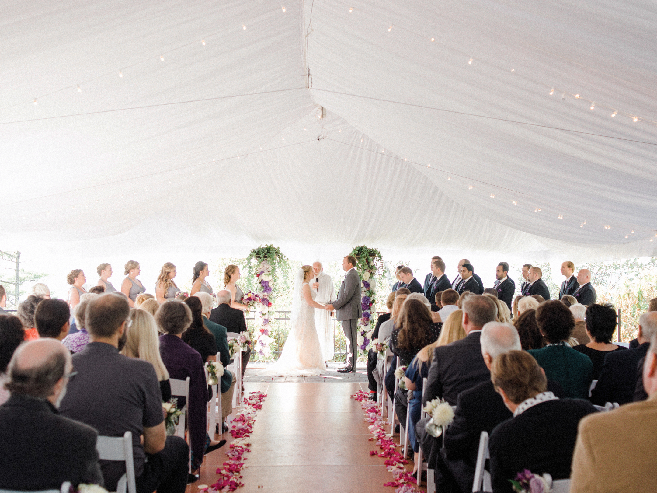 white tent wedding ceremony at horseshoe bay golf club