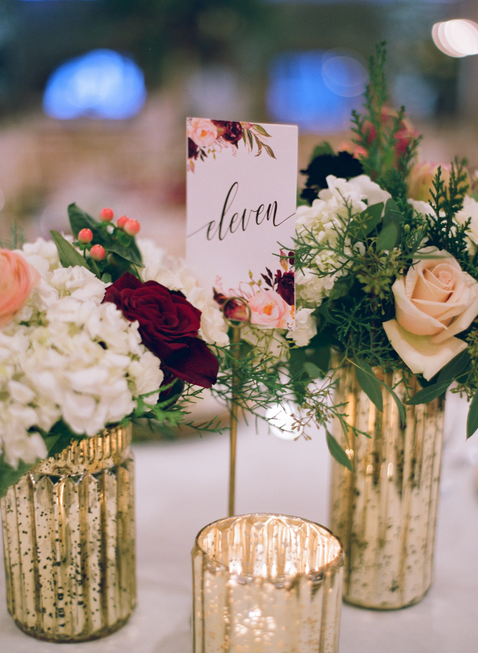 winter wedding reception table decor in burgundy and gold