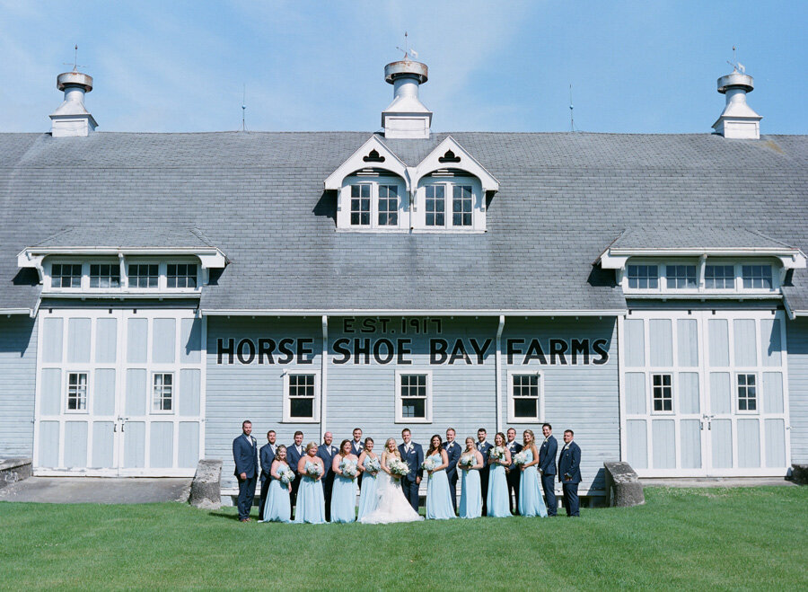 Wedding party in front of the iconic Horseshoe Bay Barns