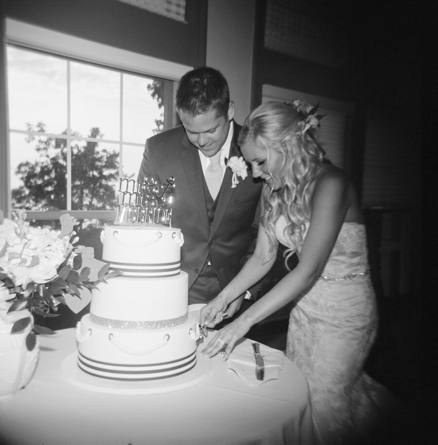 Bride and Groom cut the cake photographed with film on a Holga camera