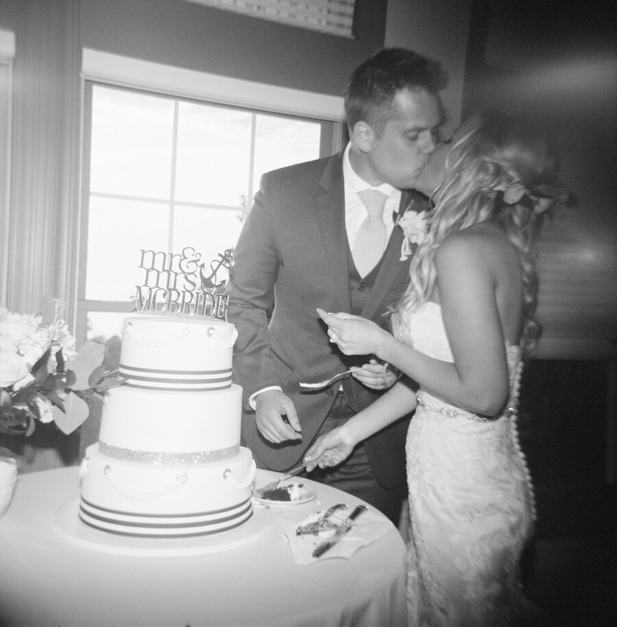 Bride and Groom cut the cake photographed with film on a Holga camera