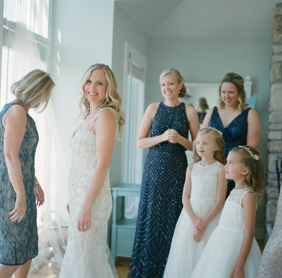 sister bay door county wedding flower girls looking at bride