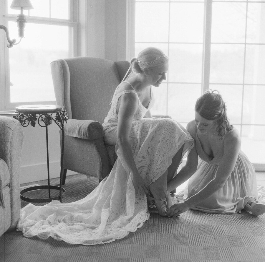 bride putting on jimmy choos at getting ready cottage at horseshoe bay golf club