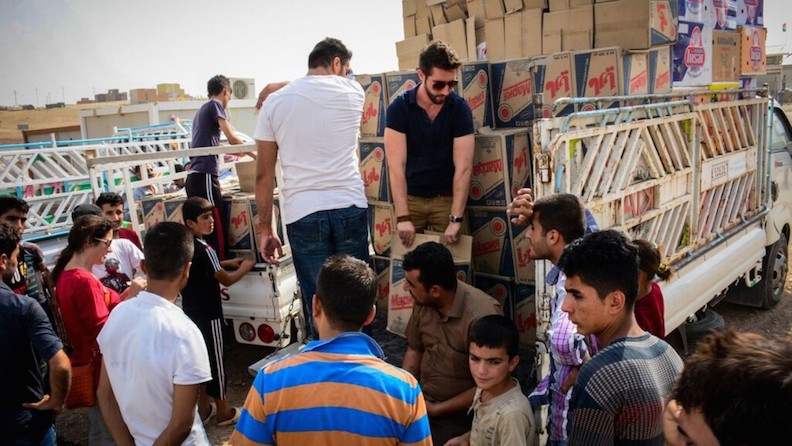 (IsraAID relief volunteers distributing supplies in Iraq last month. Photo: courtesy)