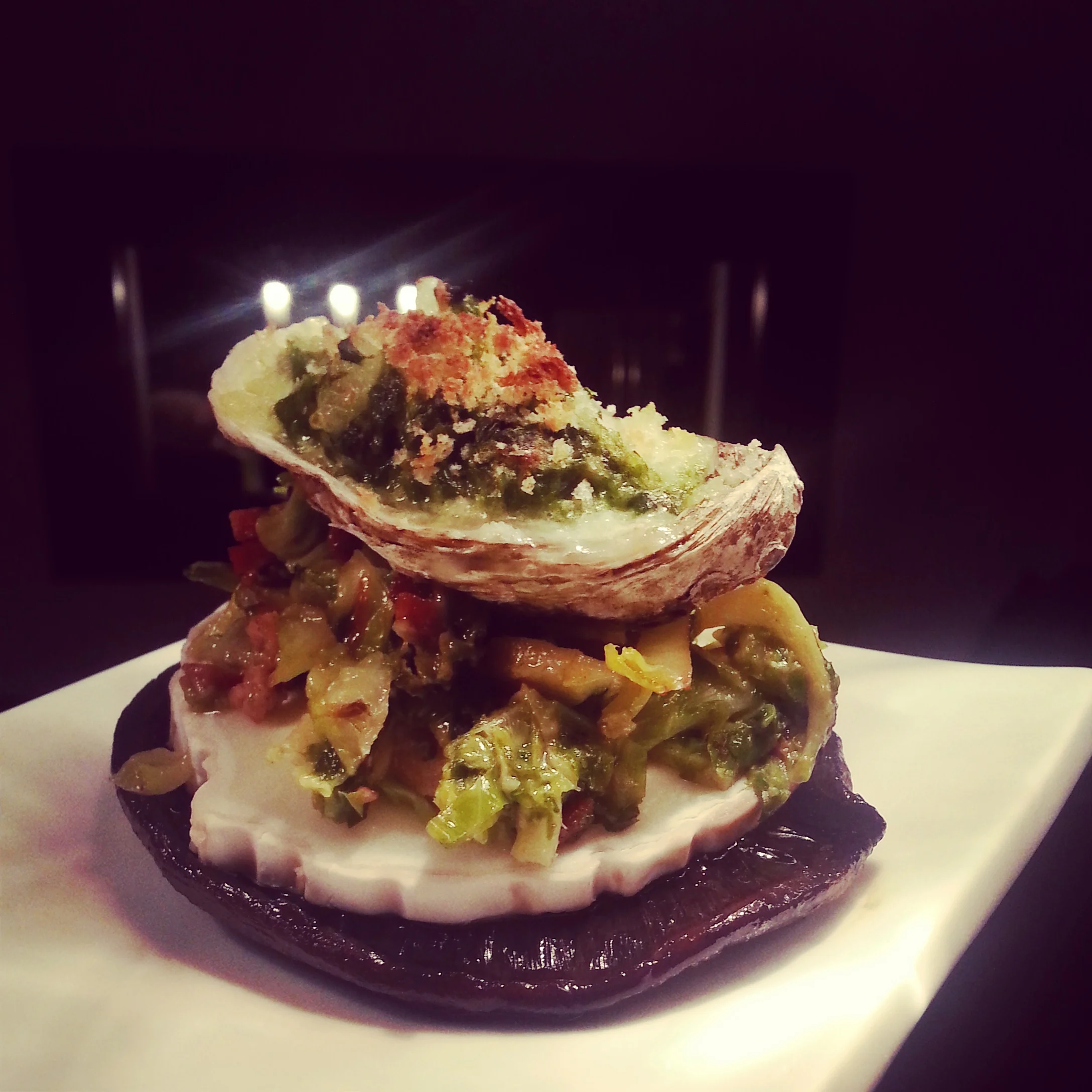 Rockefeller Oyster served on a Brussel Sprout Slaw with a Goat Cheese and Portobello Mushroom base.