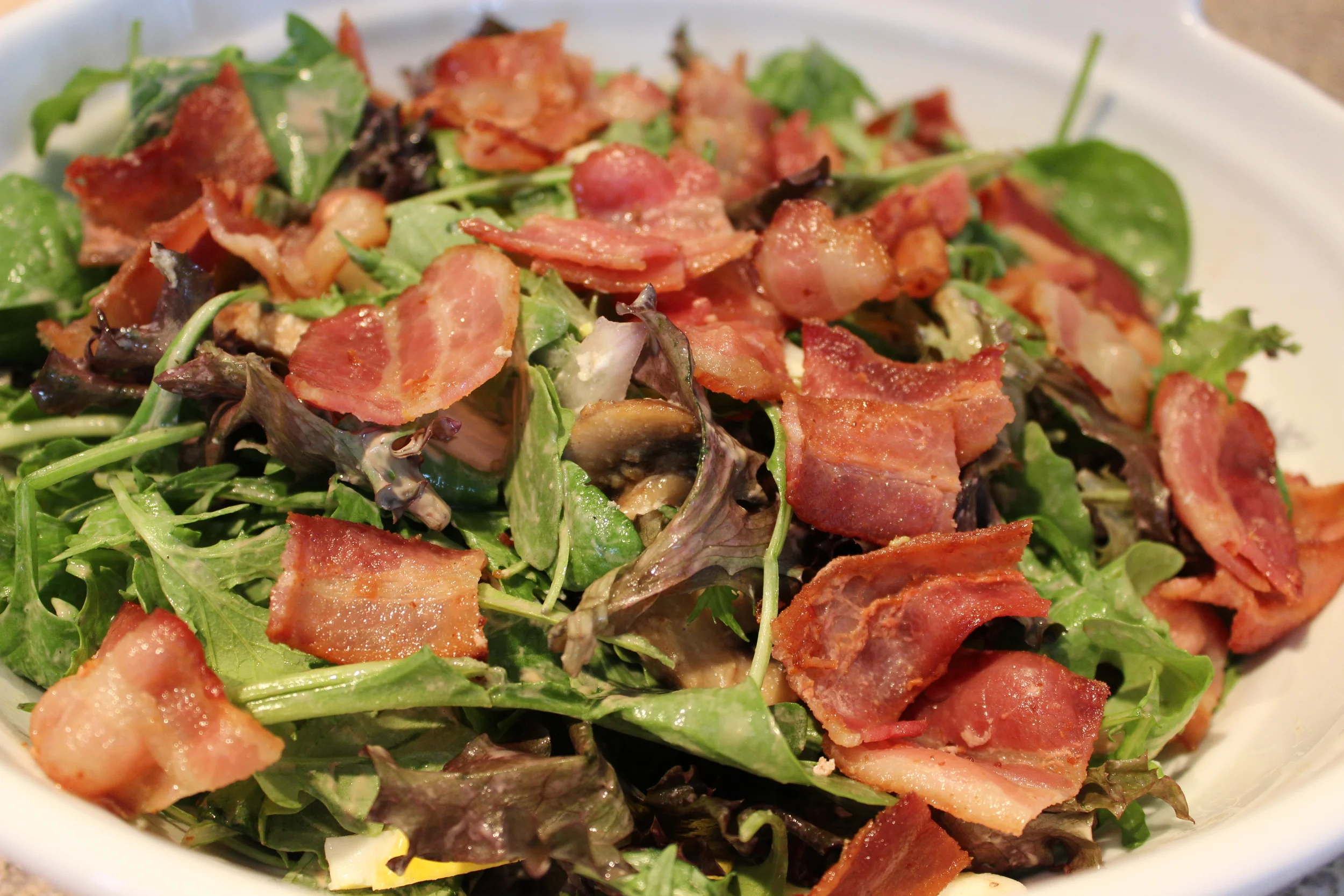 Spring Green Salad with Sautéed Mushrooms and Fried Eggs, topped with Crispy Bacon. 