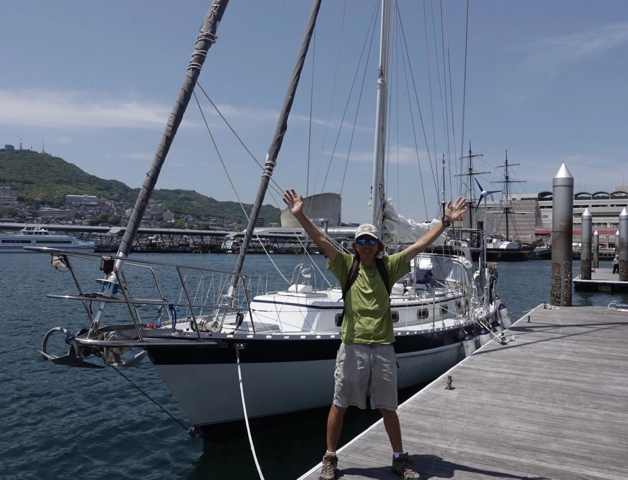 Douglas and Tumbleweed at Dejima Marina with a bit of Nagasaki in the background.