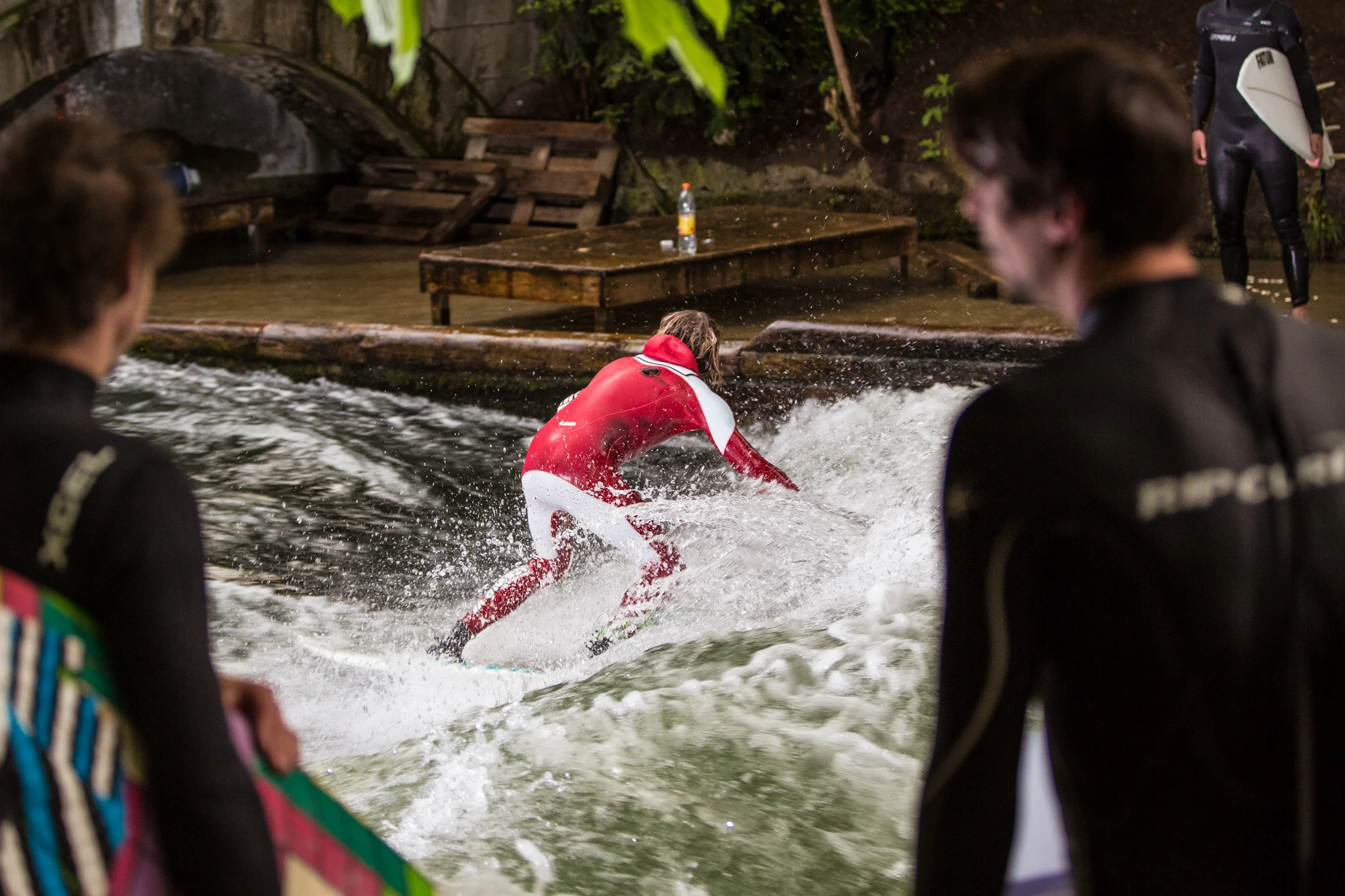 surfers surfing on eisbach river munich