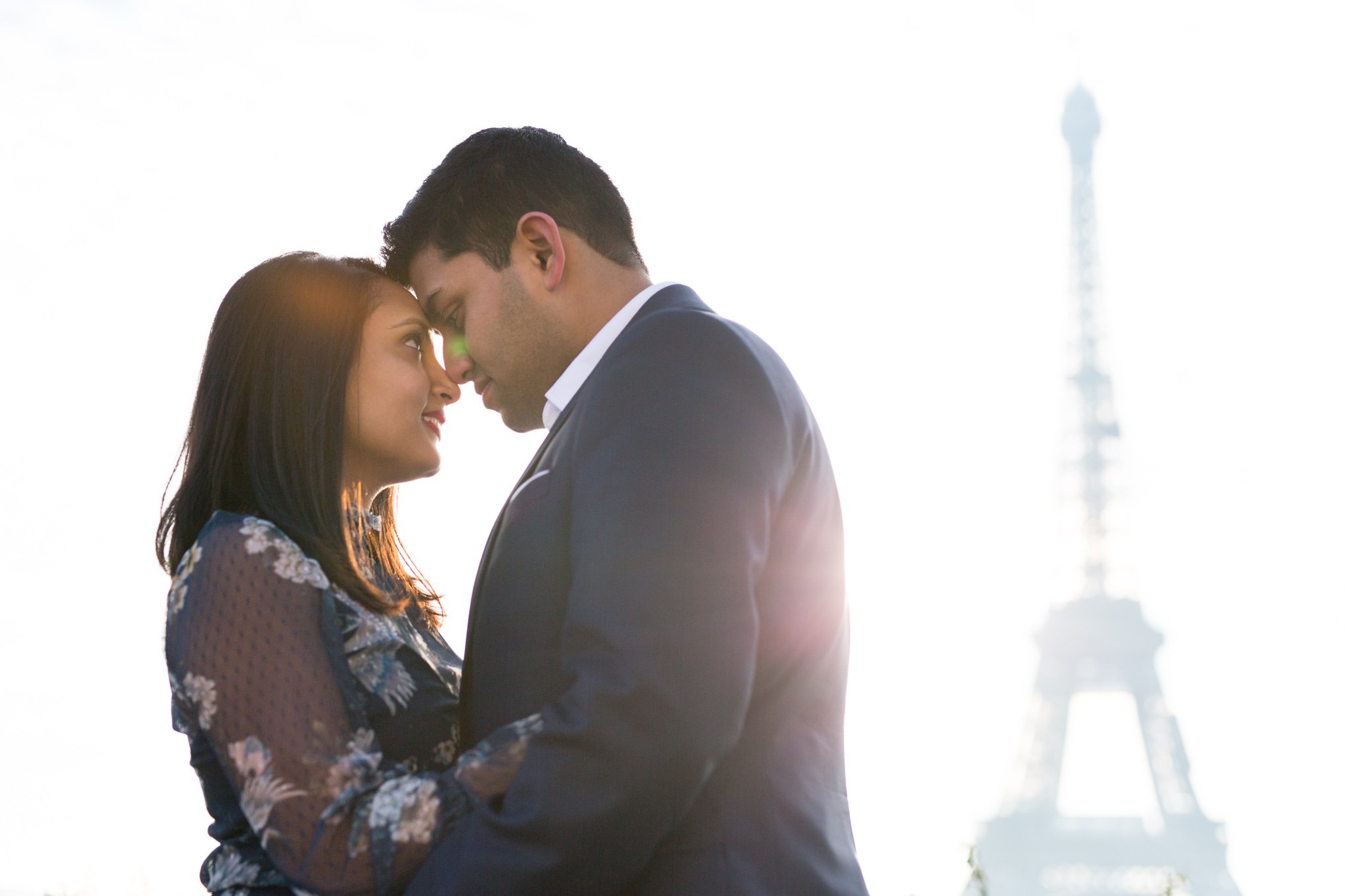  engaged-couple-embrace-in-paris-sun 
