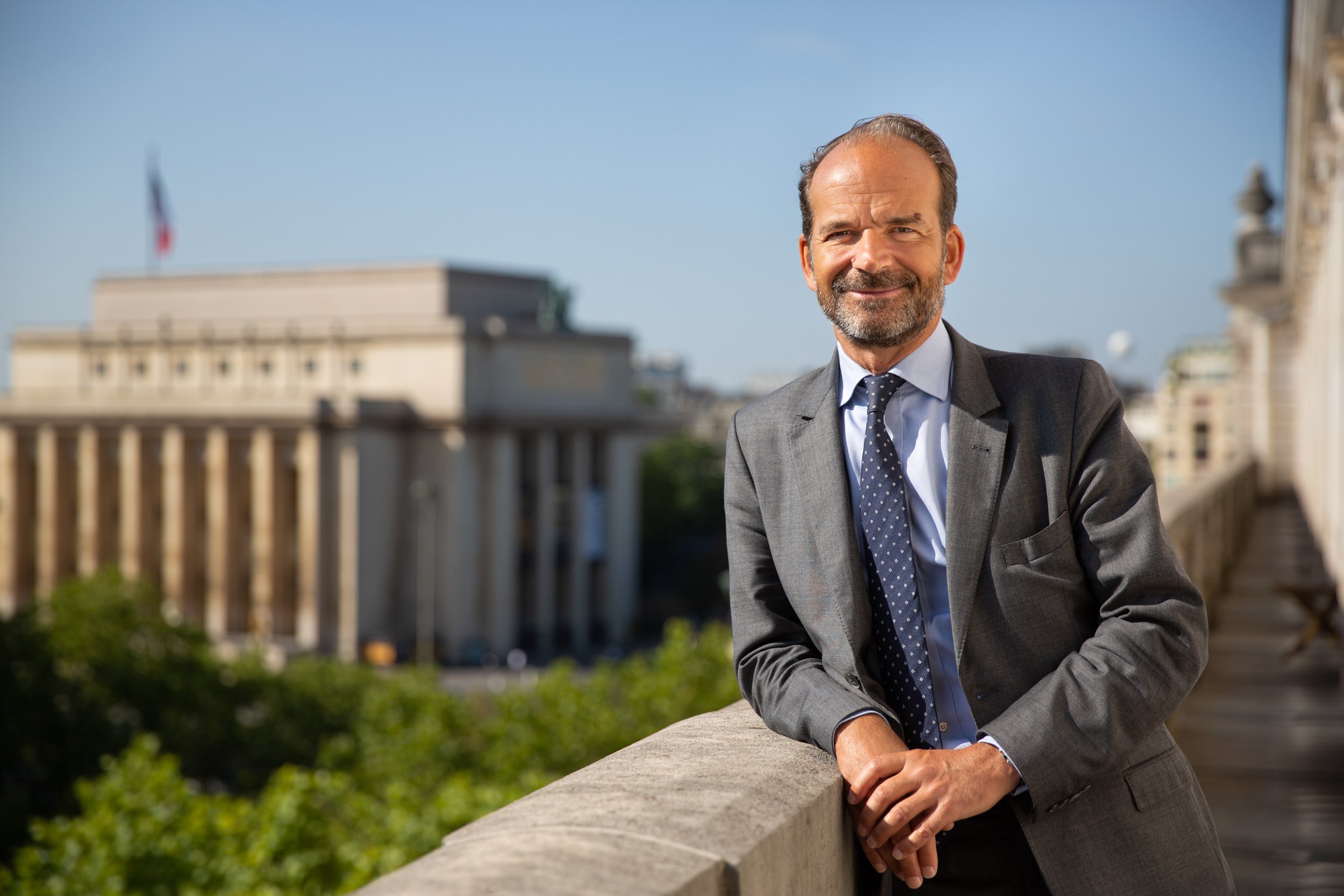  businessman-poses-at-trocadero-office 