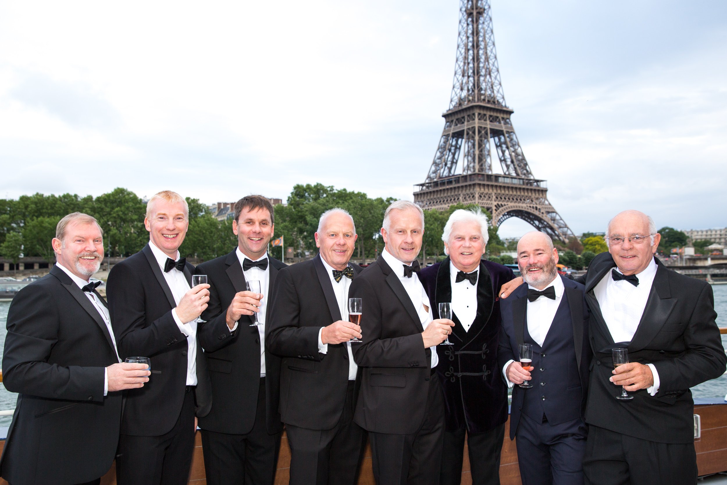  group-of-ceo-guests-toast-future-by-seine-on-river-cruise 