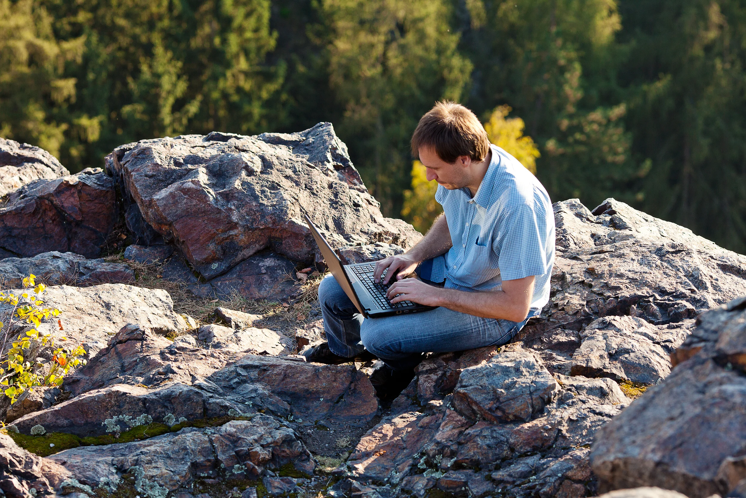 bigstock-Young-Man-Using-Laptop-Sitting-24544607.jpg