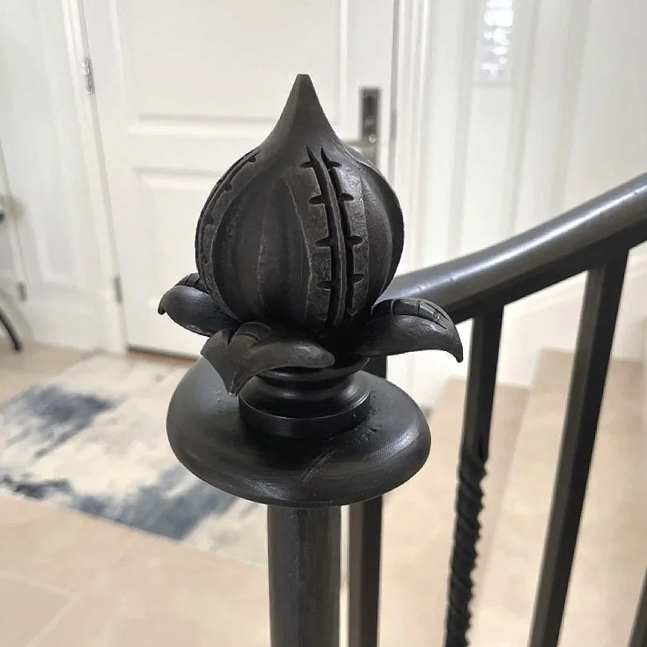 A Railing Newel Post Finial made by Smith Shop in 2025 featuring a forged bulb shaped and repoussé leaves