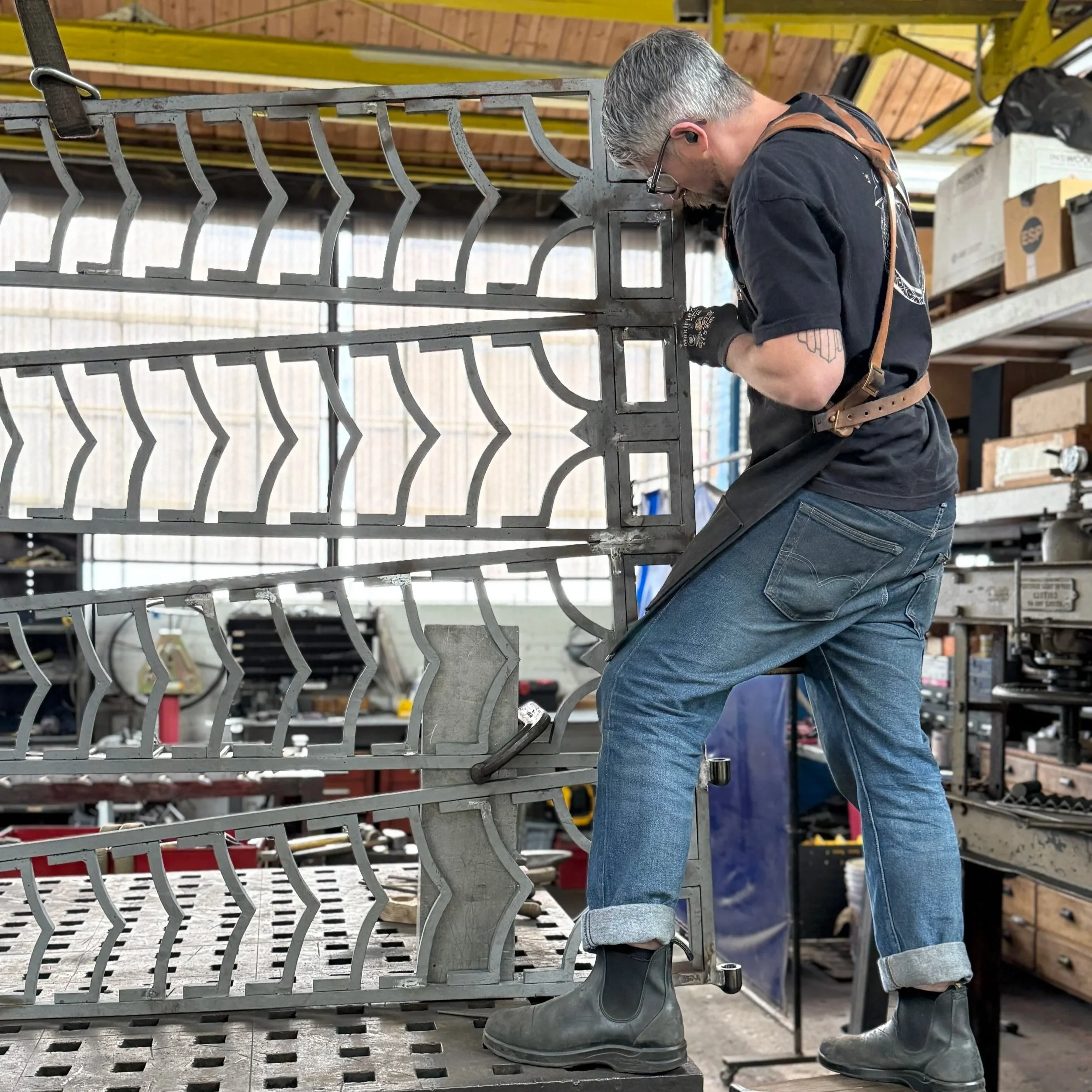 Gabriel Craig works on restoration of the Cranbrook Kingswood Gate designed by Eliel Saarinen in 1931.