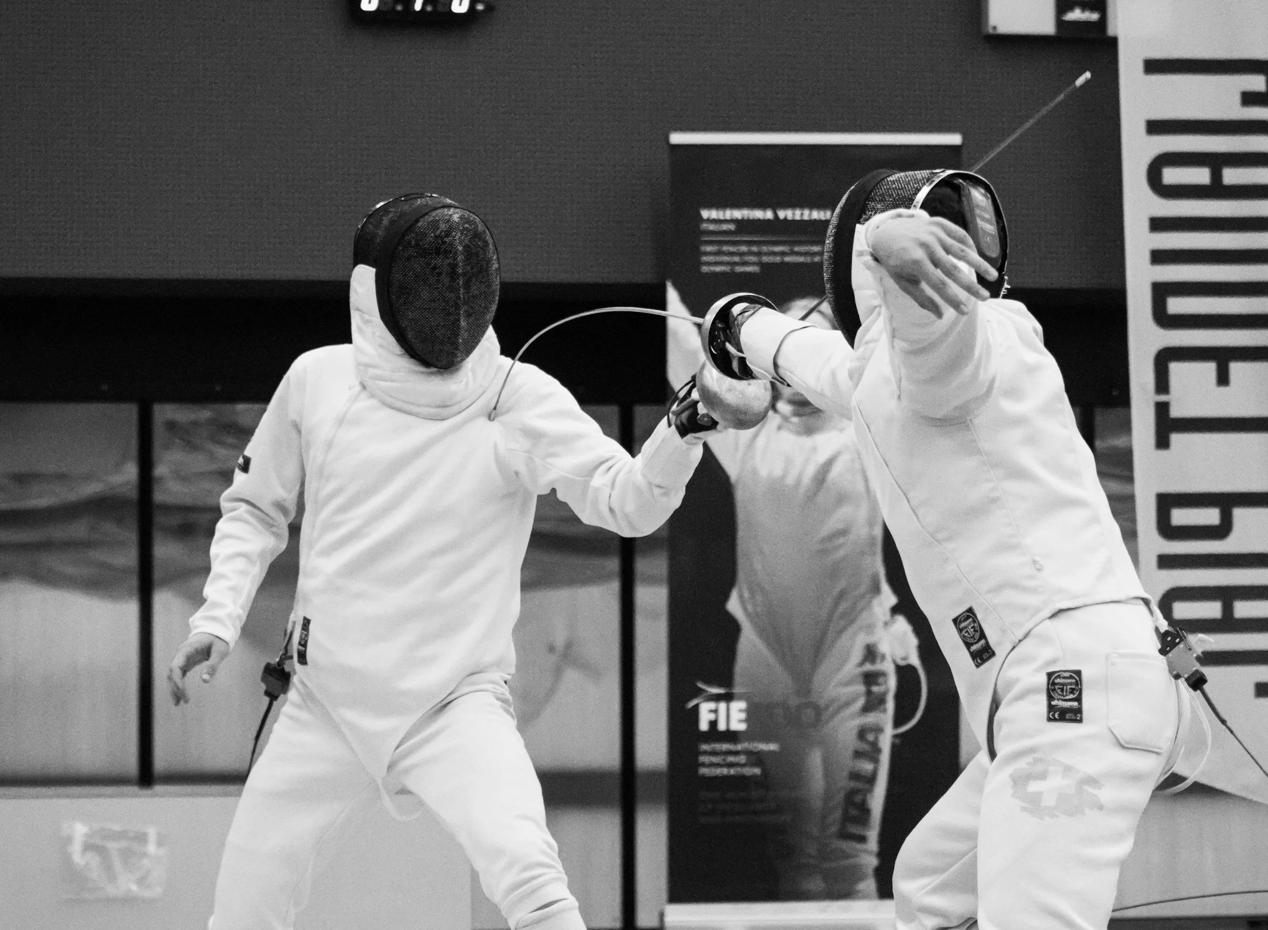 A fencer scores a touch with an epee