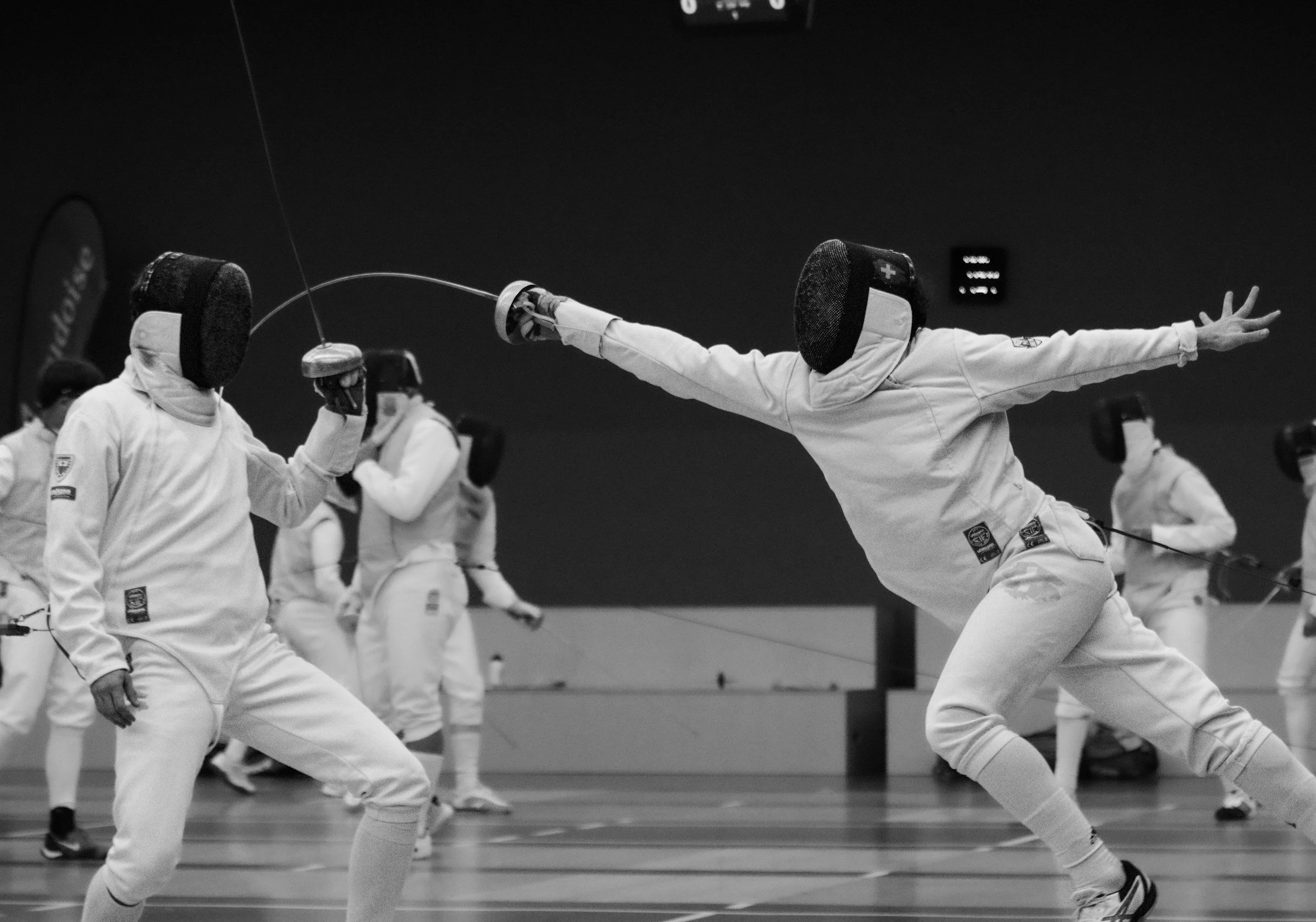A fencer scores a touch with a fleche