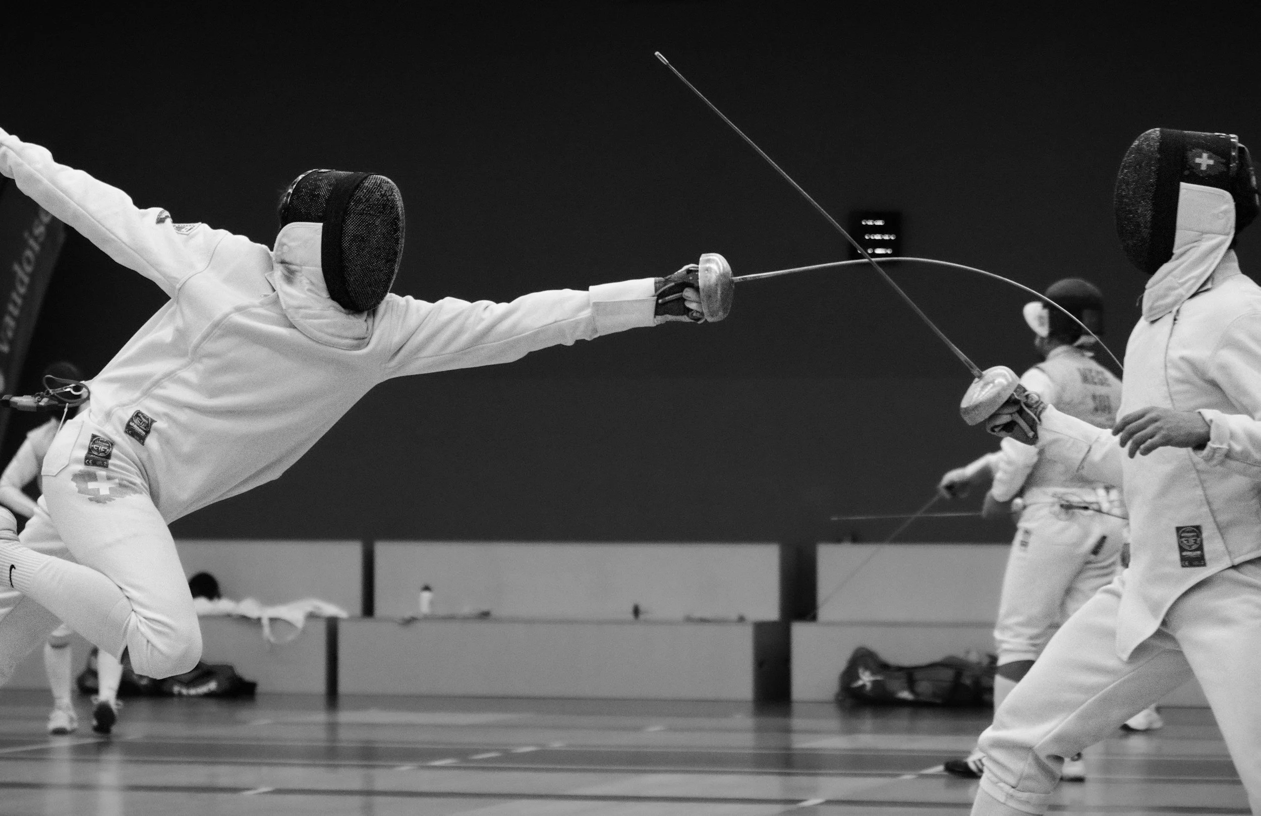 A fencer scores a touch with a fleche