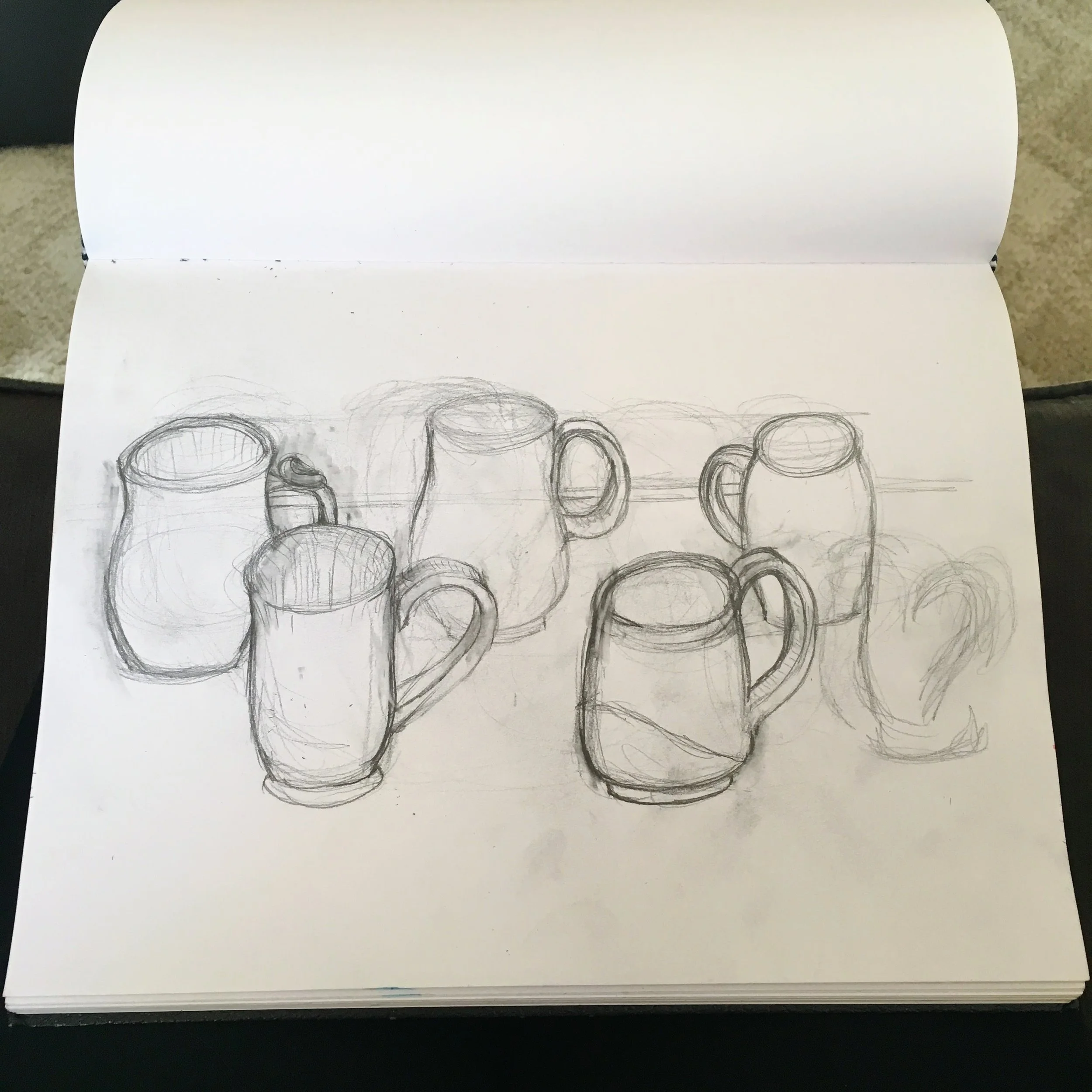 Kicked Winston off my lap and now I'm going through and firming up all of the outlines and distances between the mugs. Also, I've let the last mug in the bottom row go. I realized in my beginning sketch that if I wanted to keep that mug in the composition I'd have to make everything smaller, but I liked the size I had going for the mugs so my choices became to either have one of the mugs running off the side of the page or eliminate it. I decided to eliminate it so that I would end up with a more solid overall composition.
