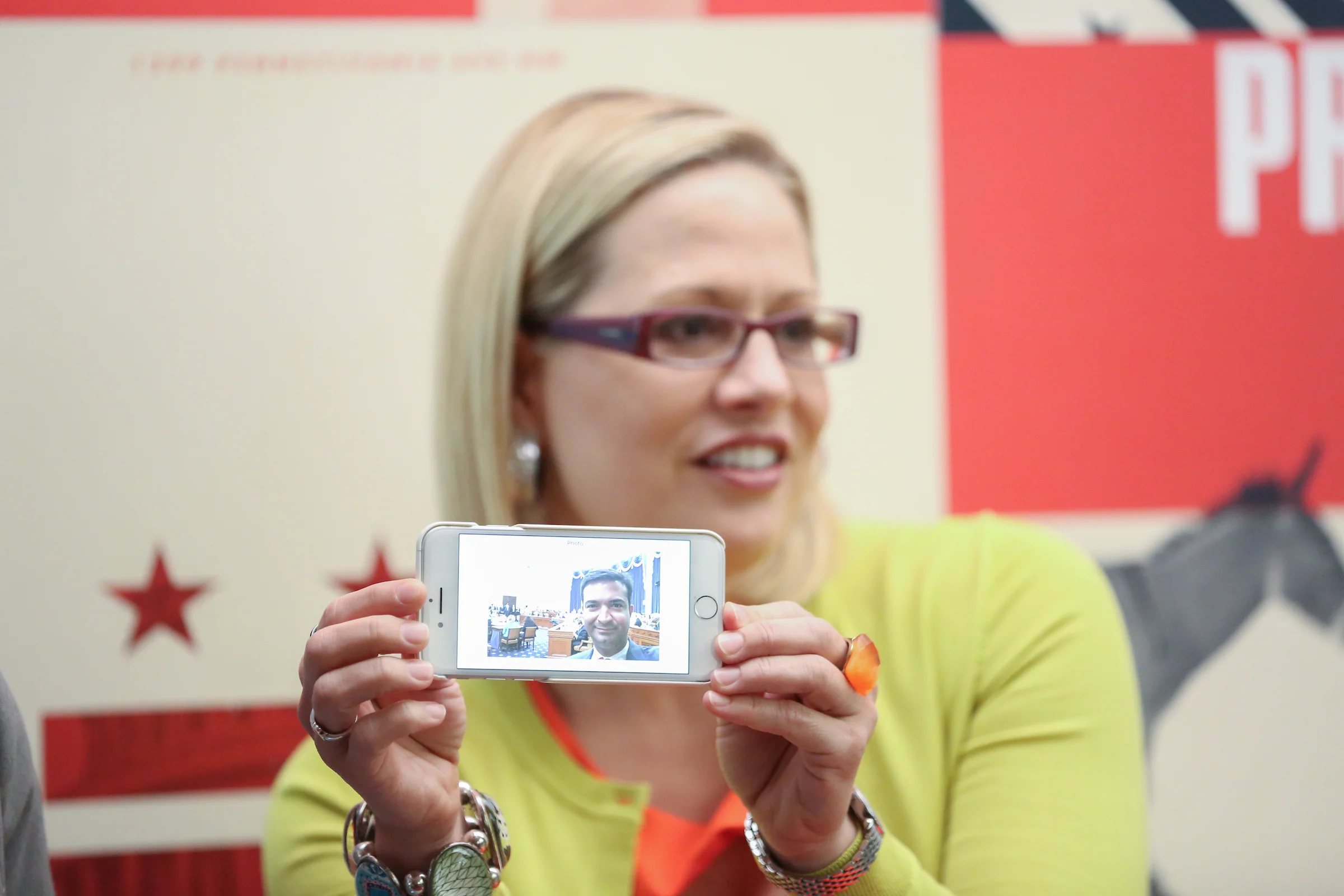 Rep. Sinema shares a photo texted to her by Rep. Curbelo, who was unable to attend the event due to a hearing in the House Ways and Means Committee. (Credit: Ralph Alswang Photography)