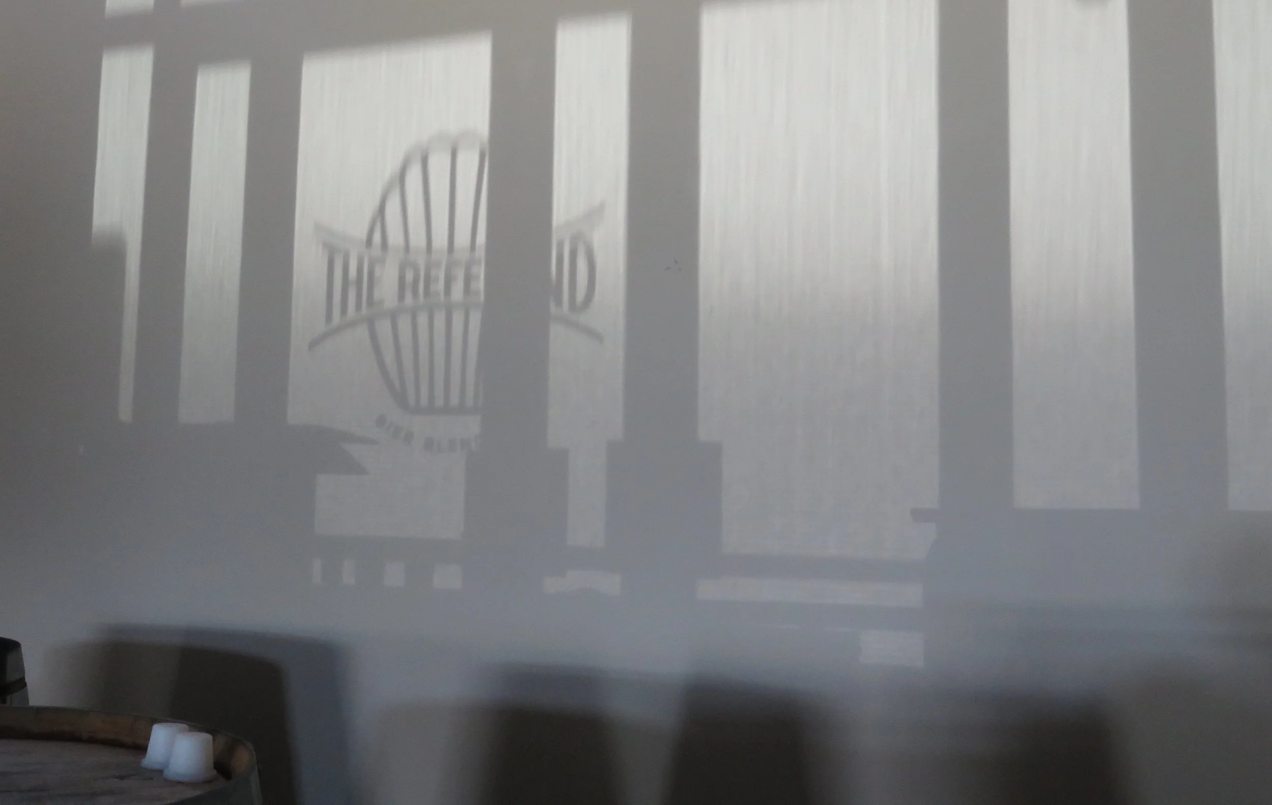 The front door madeleine signage spontaneously projected upon the rear wall on a hot day
