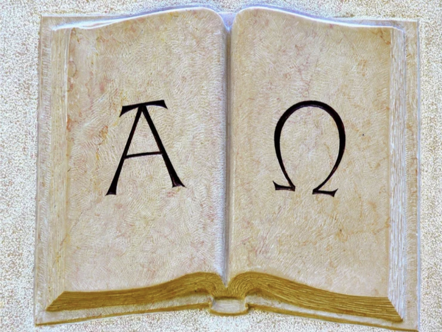 Alpha and Omega on an illustrated open Bible