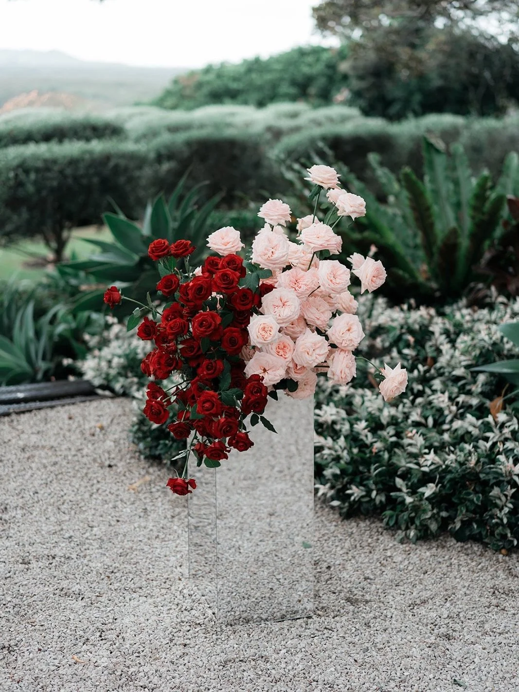 There is something so striking about the way our mirrored plinths interact with a space. By reflecting the natural textures of the landscape&mdash;from crushed gravel to lush greenery&mdash;they create an illusion of flowers floating in mid-air.

@wi