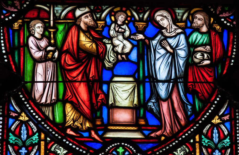 Stained Glass window depicting Simeon the Godreceiver, who met the Child Jesus in the Temple in Jerusalem, located in the Cathedral of Brussels, Belgium. Credit: jorisvo / Shutterstock, Inc.