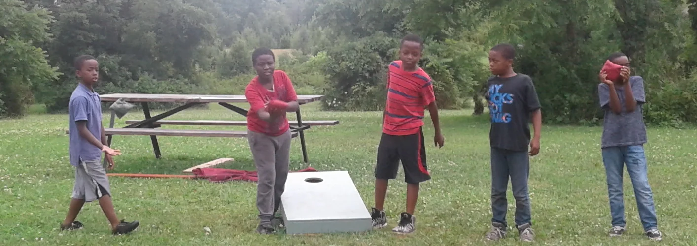 Homeport kids enjoy a game of Cornhole while visiting Olentangy Indian Caverns
