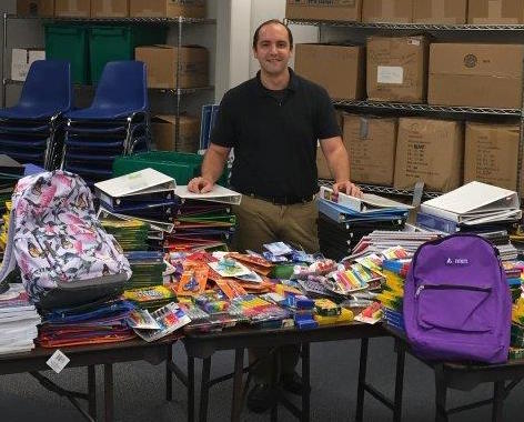 Andrew Bertolino with back to school supplies collected at Starbucks for Homeport children.