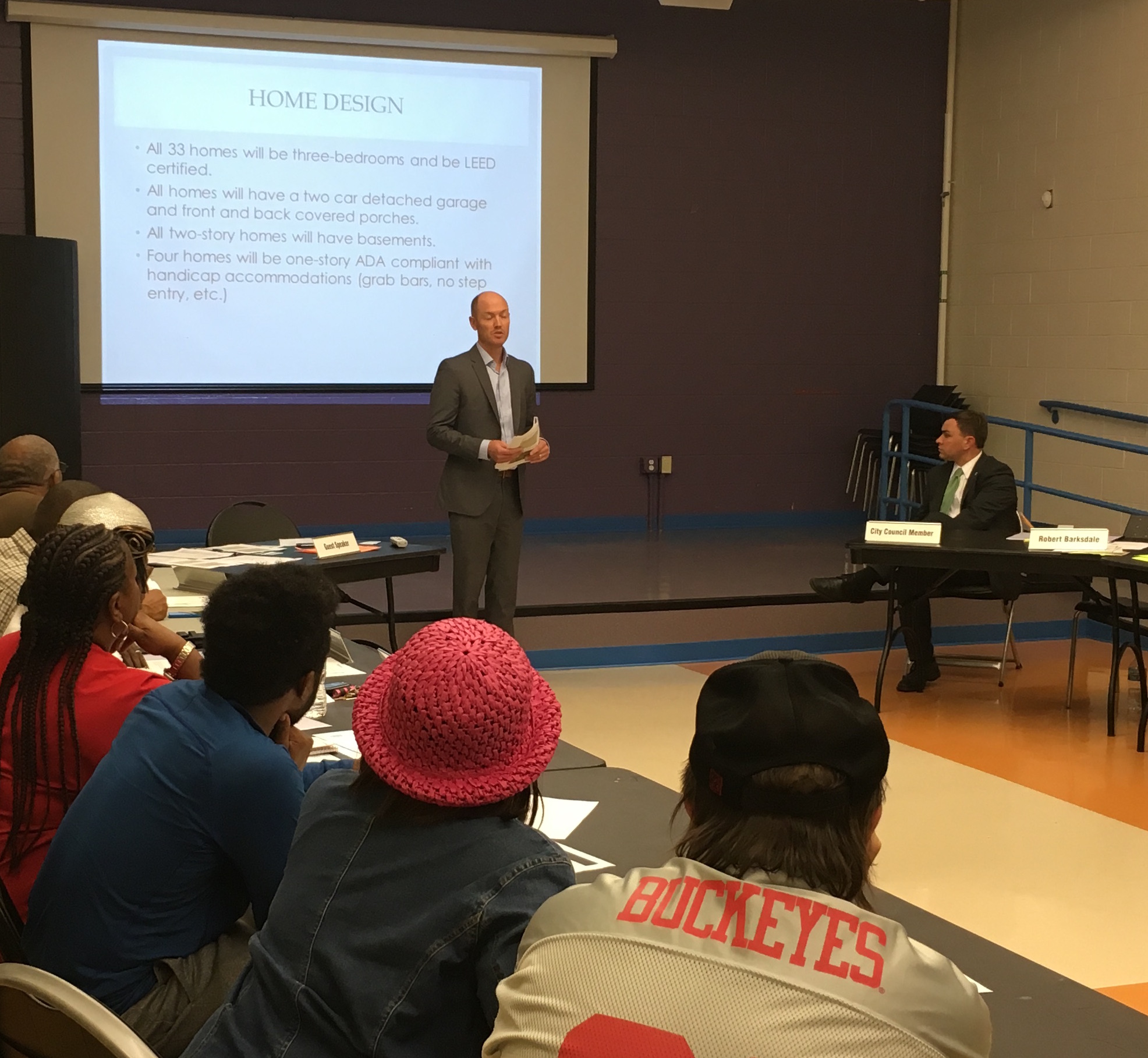 Homeport Project Manager Justin Metzler at presentation on Milo-Grogan development; On right, City Council Member Michael Stinziano listens.