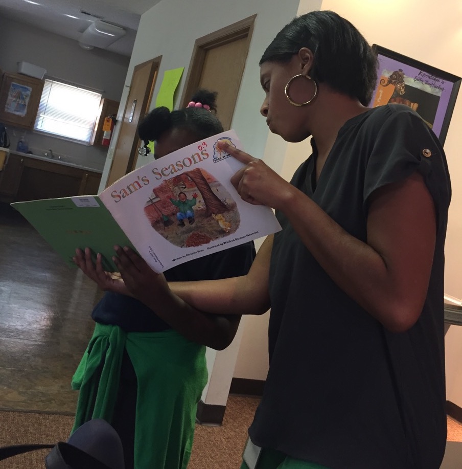 Jessica Williams reads to Marsh Run child in after school program.