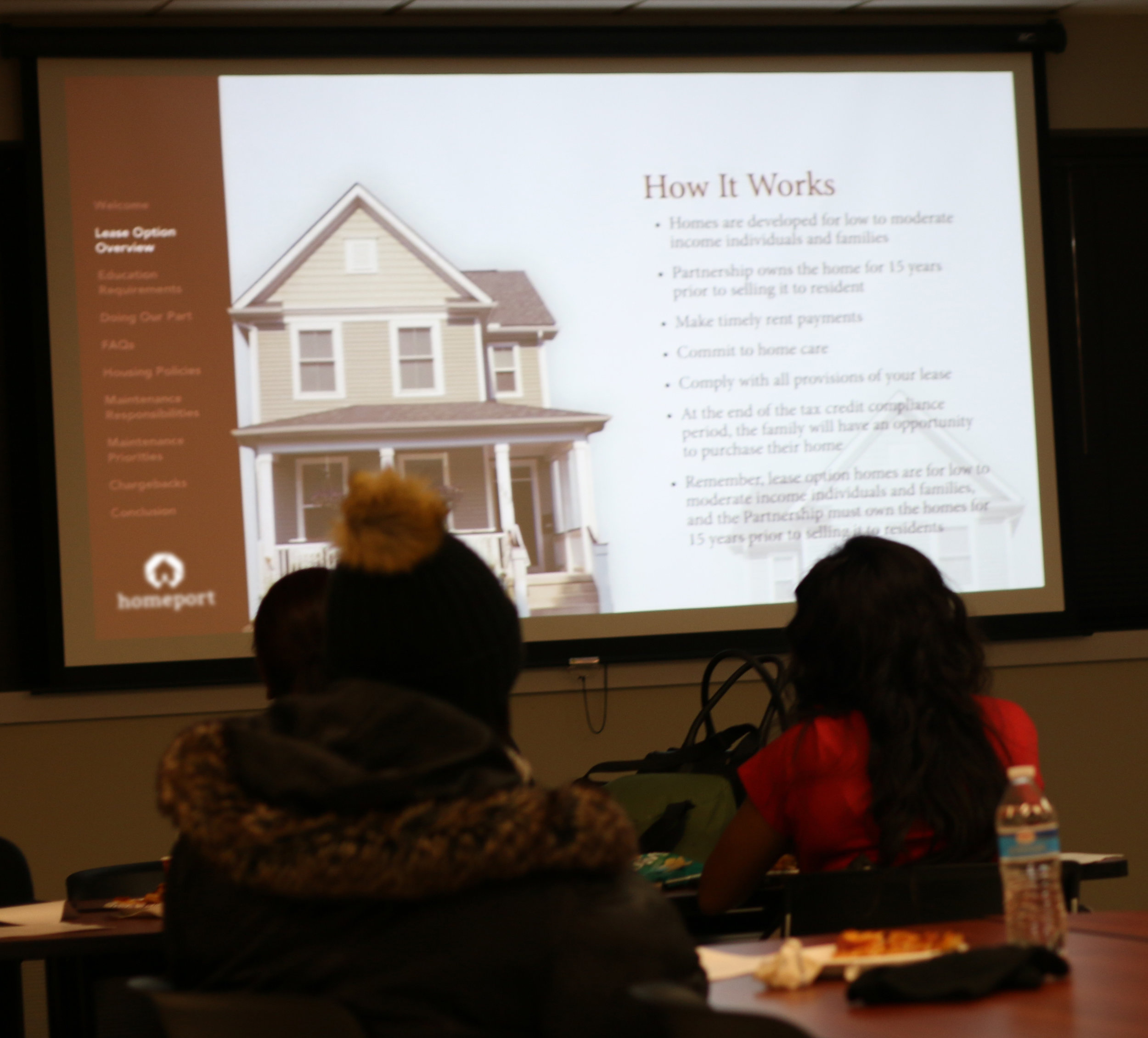 Potential homeowners from Kingsford Homes at meeting on how to purchase a home they are leasing from Homeport.
