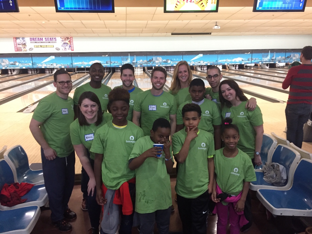 Organizers of the Homeport Young Professional bowling fund-raiser gather with Homeport resident children. The kids were chaperoned by Homeport Program Specialist Mark Childs, second from left, top.