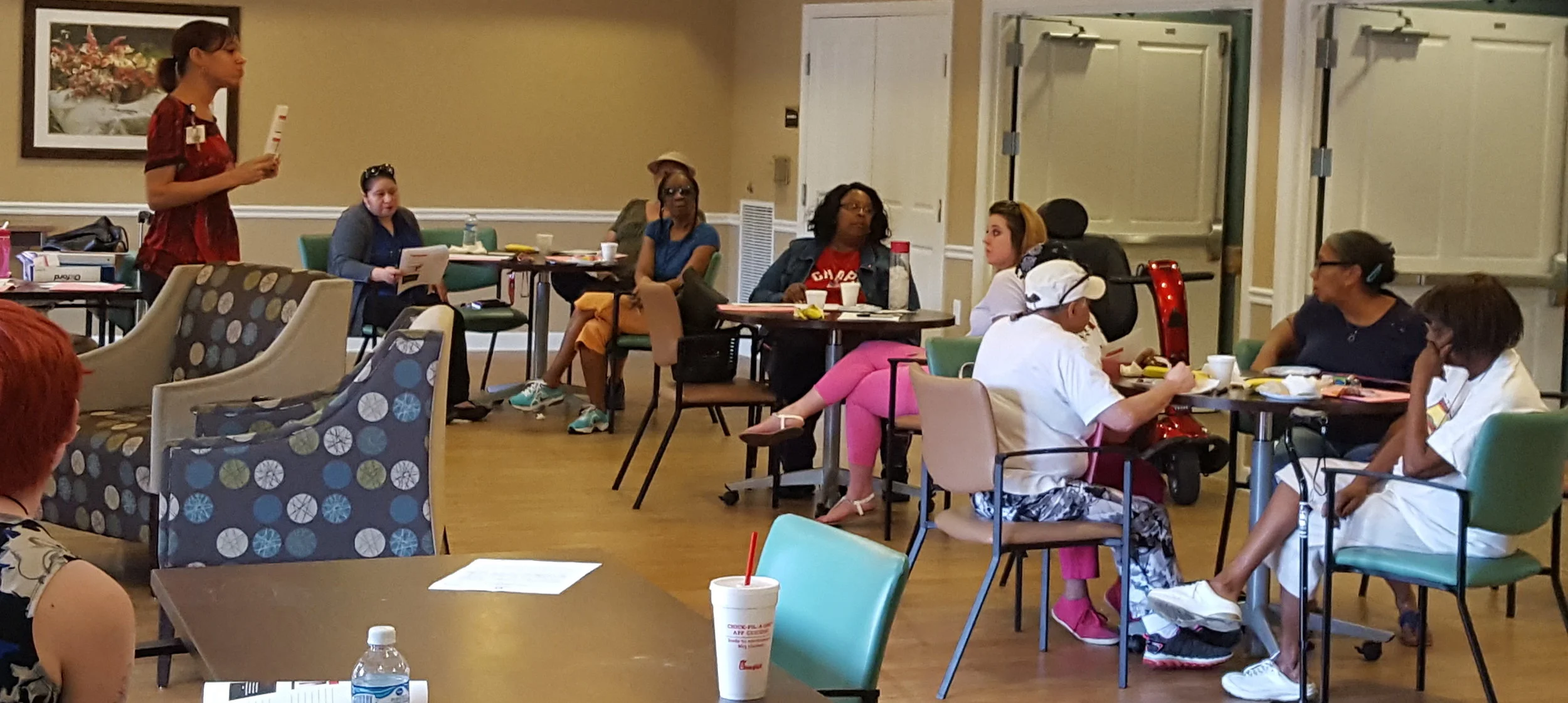 OhioHealth's Allison Payten, left, speaks to Eastway Village residents.
