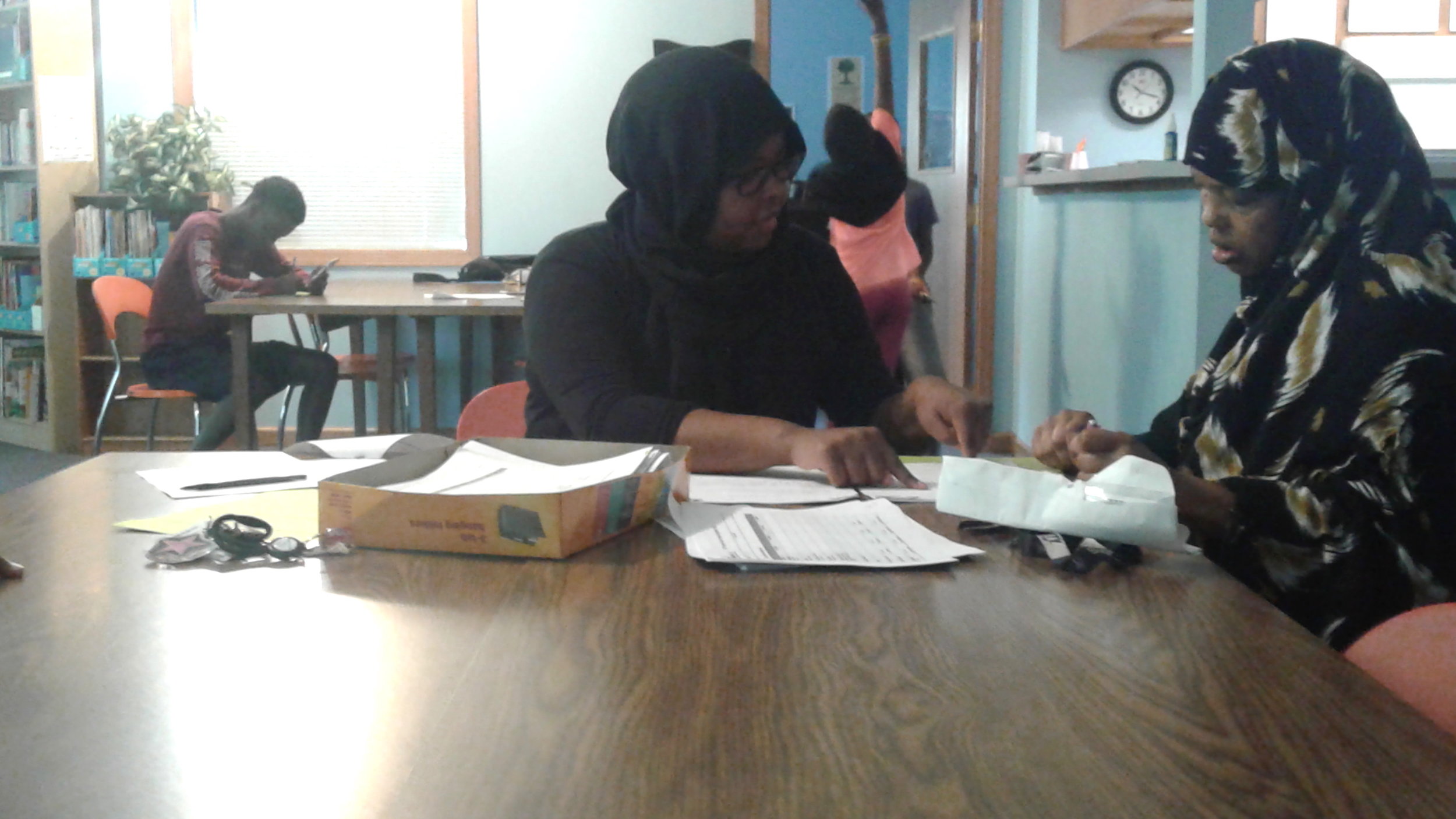 ETSS Site Coordinator Saynab Yusuf, left, at Emerald Glen summer camp registration