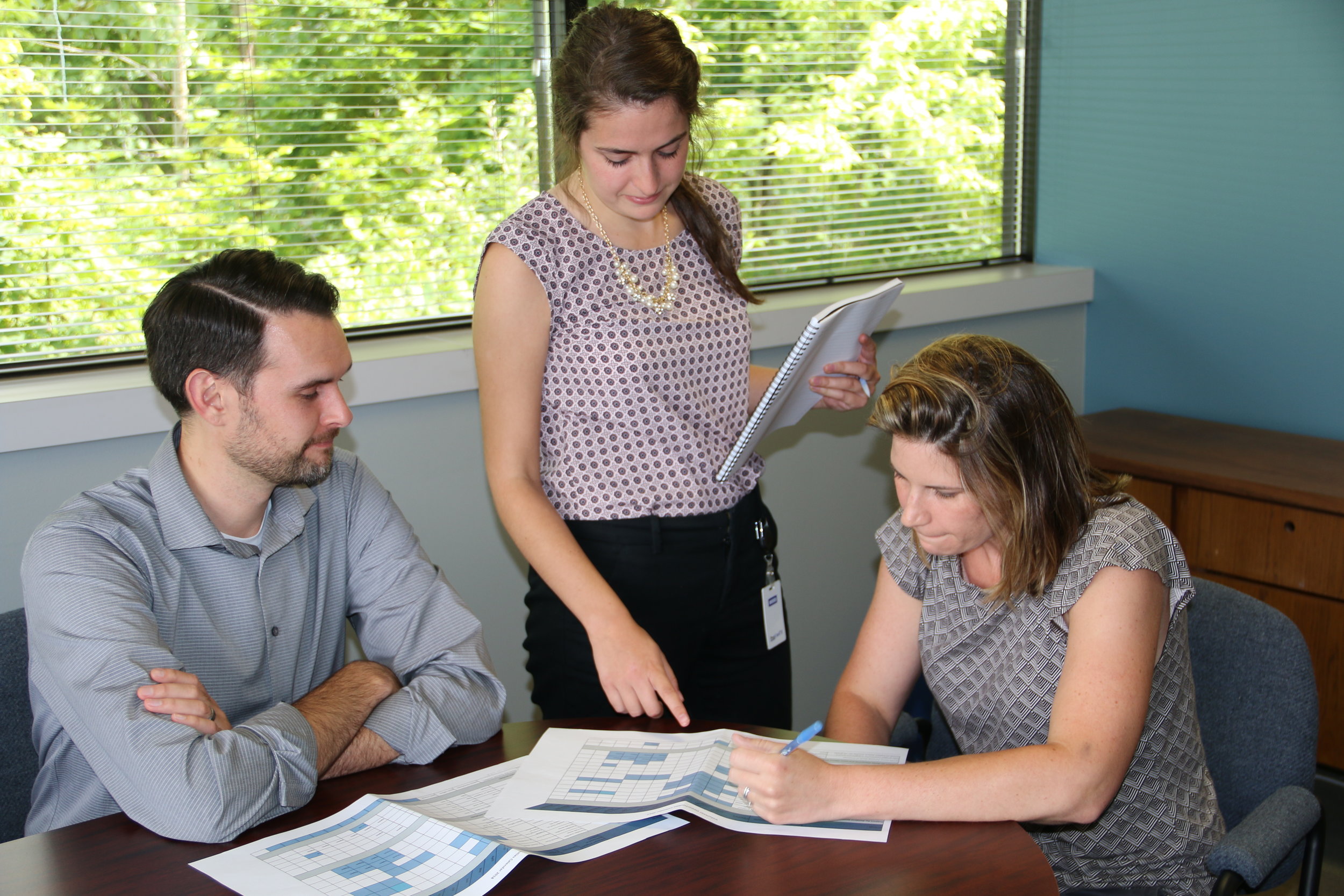 Homeport's Alex Romstedt, left, and Morgen Wade, right, review Gifts of Kindness outcomes with Columbus Foundation Fellow Caroline Corona.