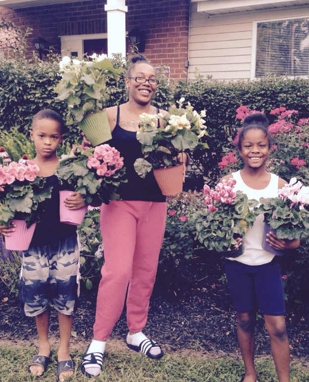 Emerald Glen resident Shelia Cunningham, and children Shamar Jenkins and Vermari Davis, participated in the flower give-away for the first time.