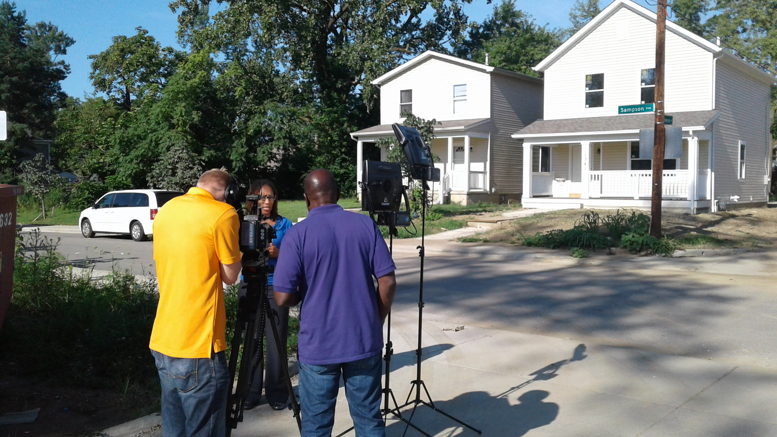 Leah Evans interviewed on Sampson Avenue by WOSU-TV across from a home being built by Homeport.