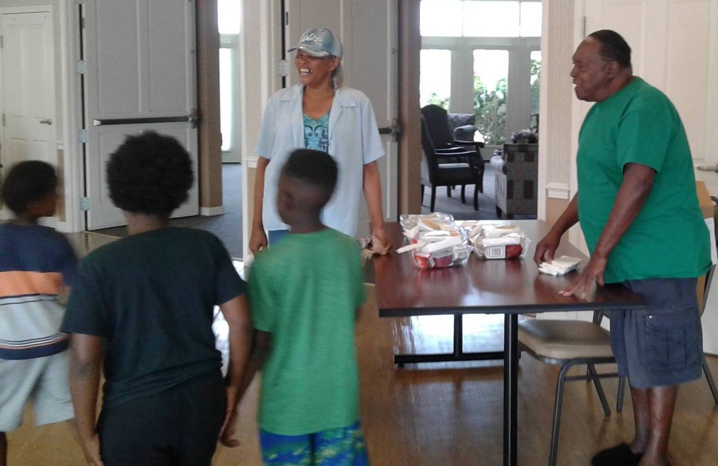 Kids ready for lunch handed to them by Elim residents.