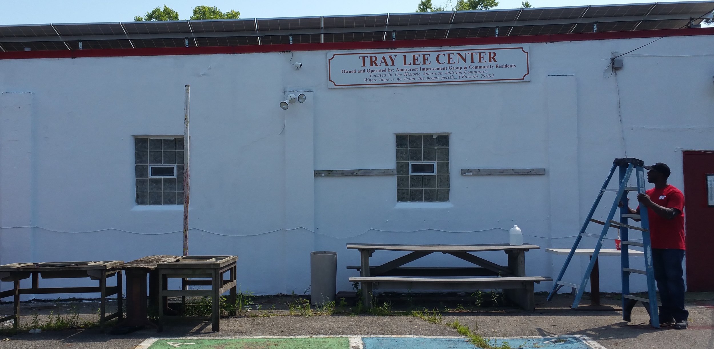 Behr Paint's Sean Miller, right, after the paint job at Tray Lee Center. Behr Paint donated the supplies.