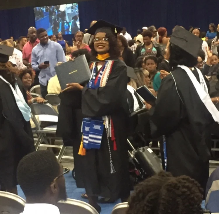 Taylor shows her diploma. She graduated with a Bachelor of Science degree in Biology.