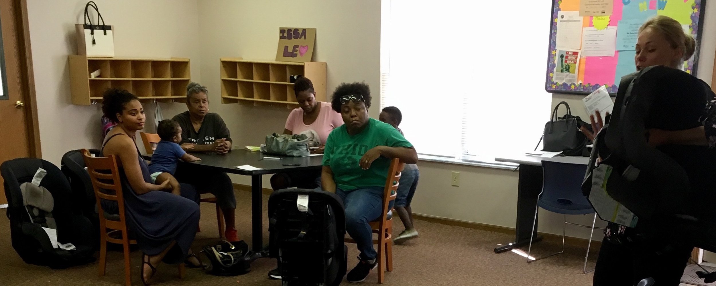 Car seat safety features were shown to residents of Marsh Run by Karisa Harvey, right, of Columbus Public Health.