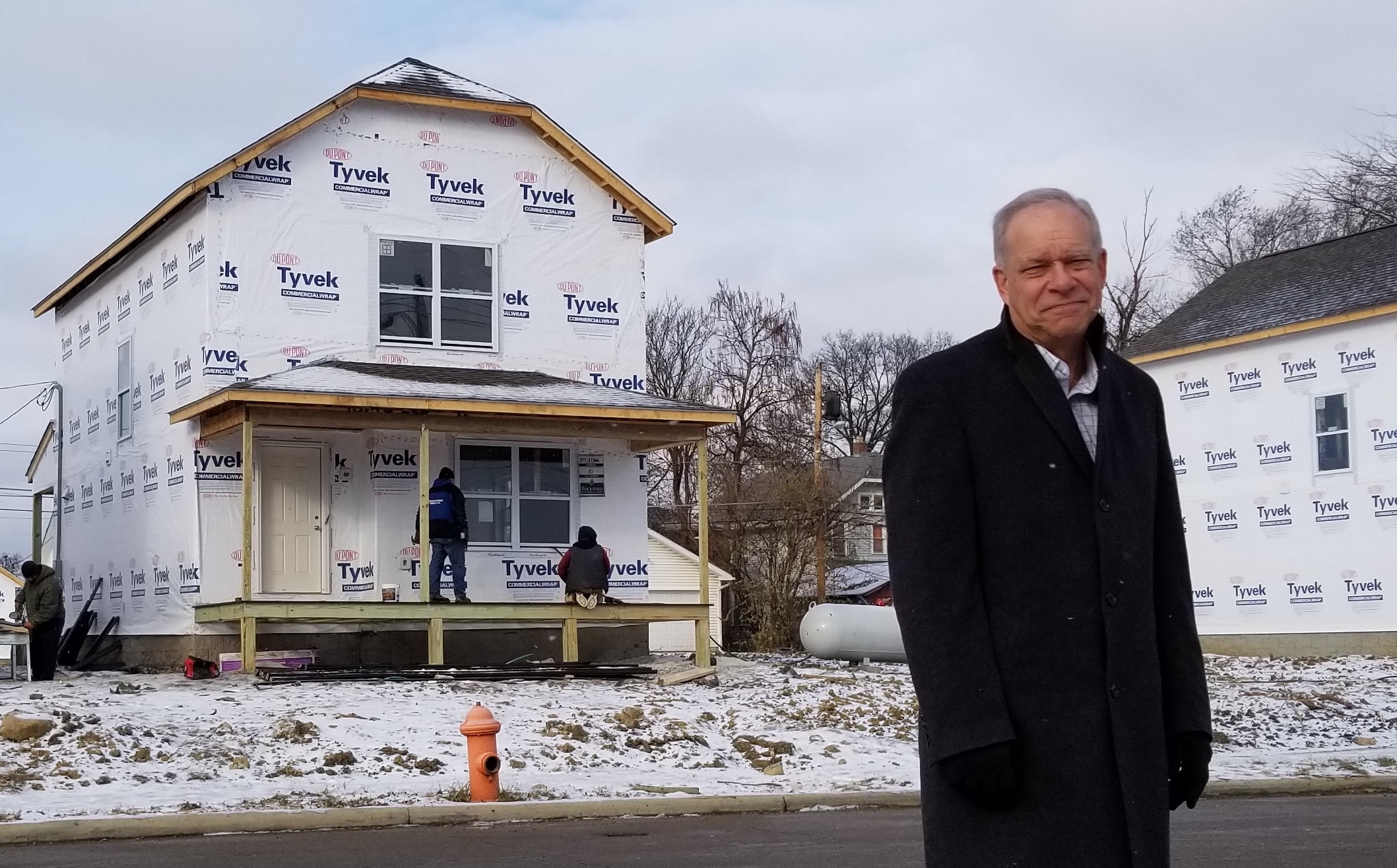 Bruce Luecke outside a Homeport house under construction in Milo-Grogan.