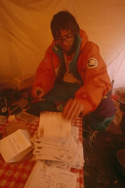 Christian de Marliave (Criquet) stamps letters for friends and sponsors with a South Pole stamp. Photo © Will Steger