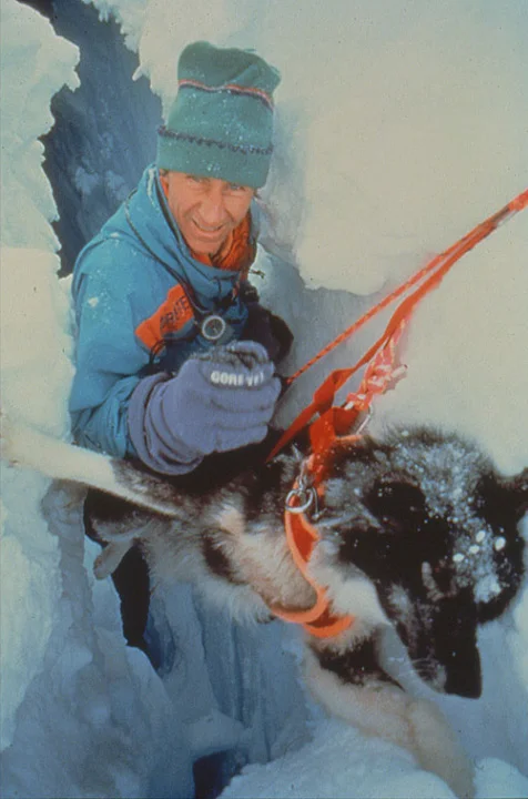 Geoff Somers rescues his dog Huck from deep crevasse. Photo © Will Steger