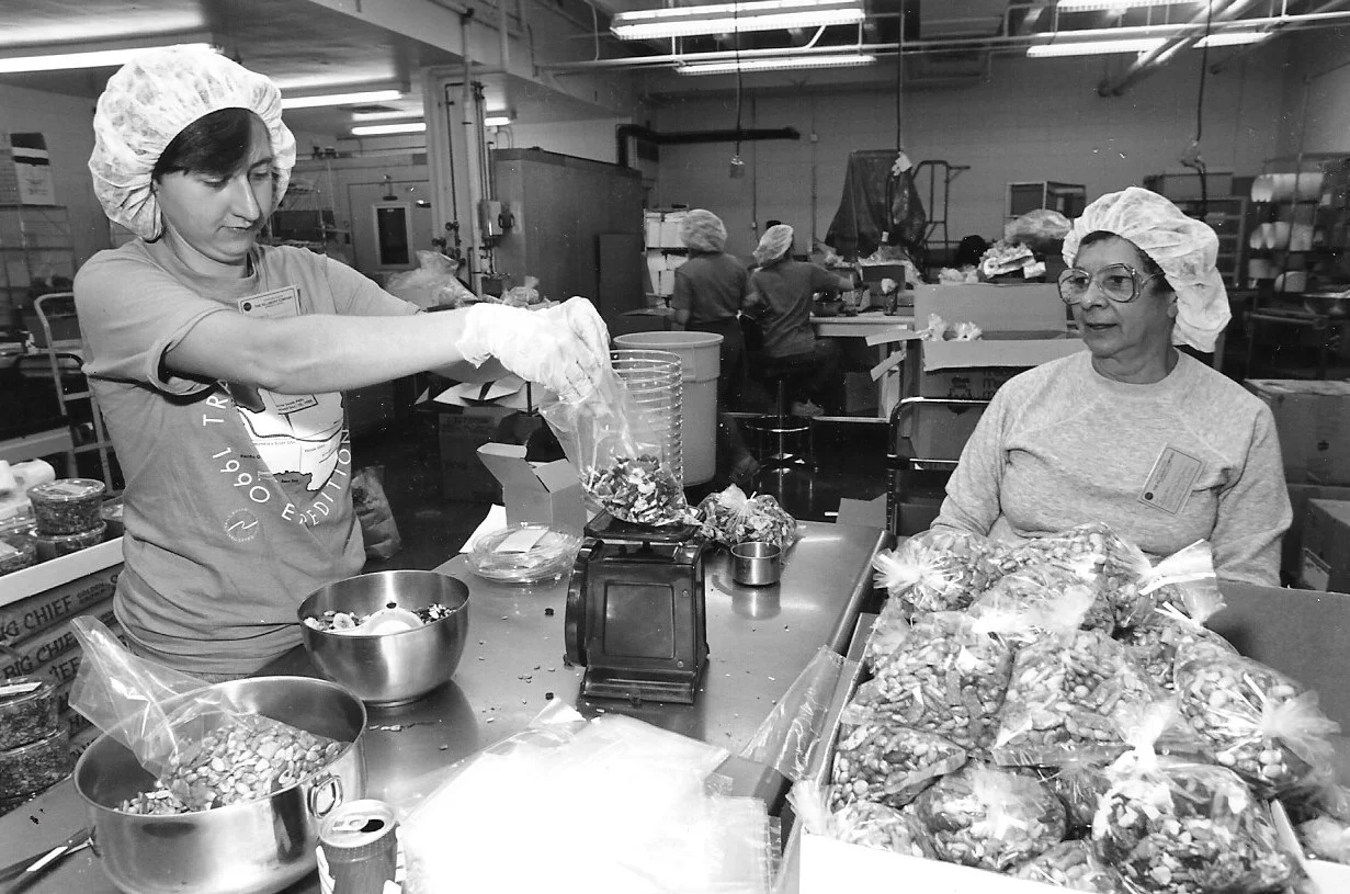 Trans-Antarctica volunteers in Minneapolis make, measure and pack high protein trail mix as part of the 7-month food supplies for the expedition. Photographer unknown. 