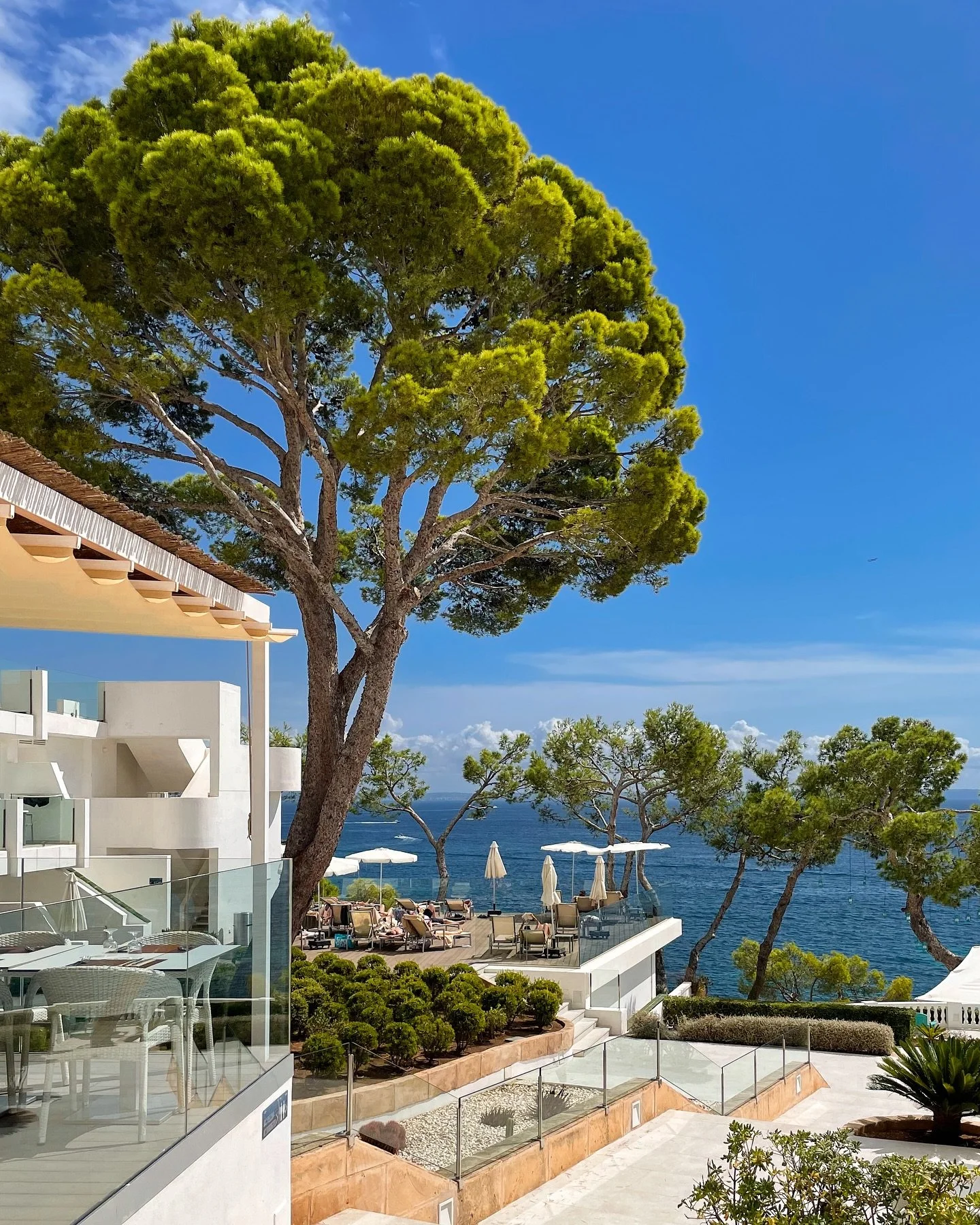 Ponent Mar Mallorca&rsquo;s outdoor space is a haven of relaxation with panoramic sea views, pine-shaded lounging areas, and a stunning seated terrace lit by lanterns. 

As dusk falls, the warm glow transforms the terrace into an intimate, atmospheri