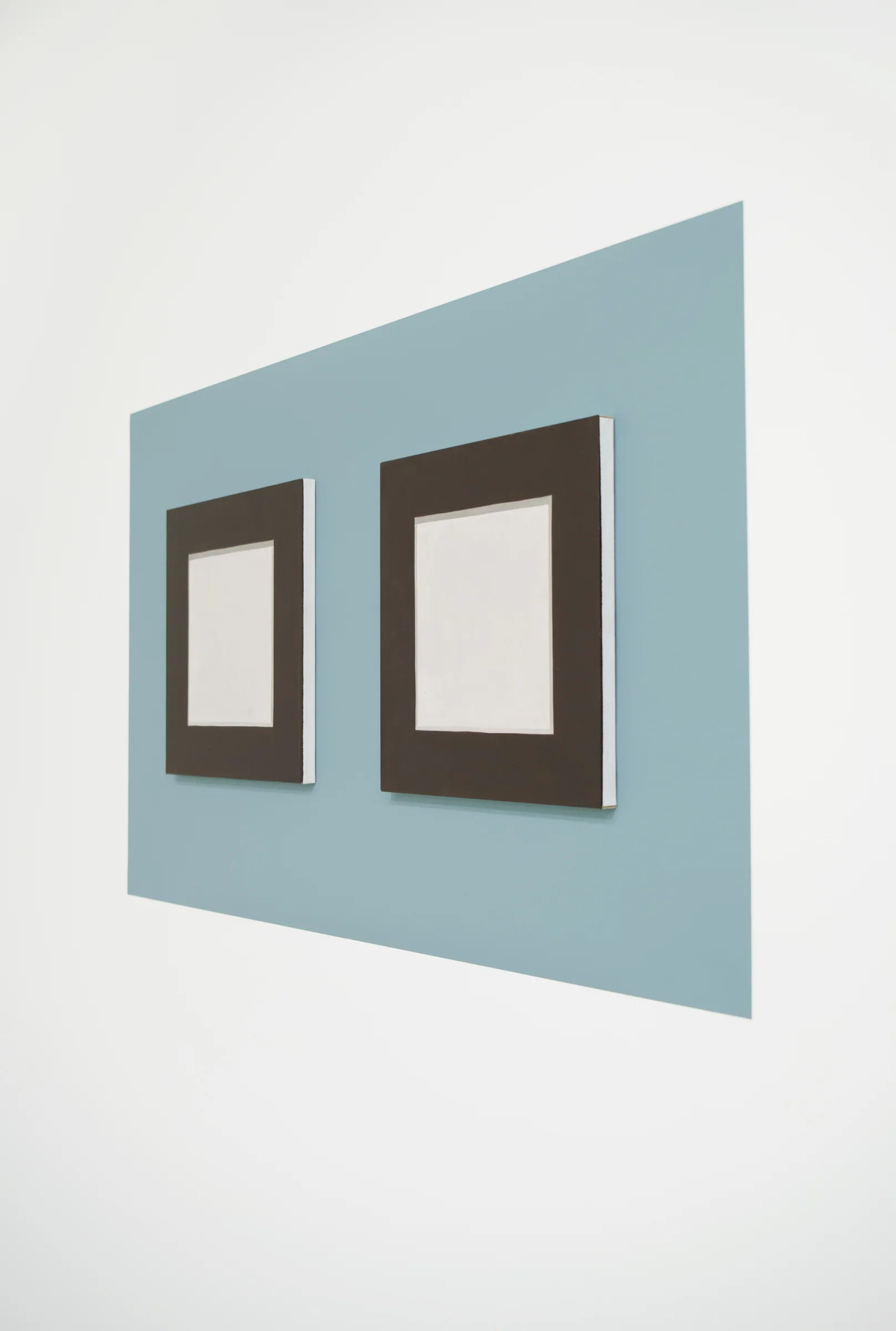 Doug No. 1 (Side View) 2018, 15” h x 26” w x 1/4” d (overall). 2 Paintings: 8” x 8” x 1/4” ea., oil on linen over panel. Wall: Benjamin Moore paint: Century Larimar #P3.
